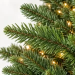4 ft Prelit Artificial Christmas Tree with 150 Lights, Lush Green PE/PVC Foliage, 714 Tips, Hinged Branches and Metal Stand